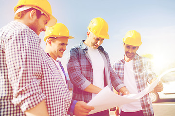 Image showing group of builders with tablet pc and blueprint