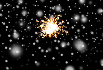 Image showing sparkler or bengal light burning over black