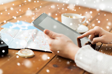Image showing close up of traveler hands with tablet pc and map