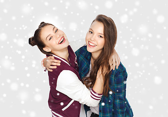 Image showing happy smiling teenage girls hugging over snow