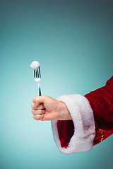 Image showing The Santa hand holding a fork