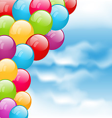 Image showing Flying colourful balloons in blue sky