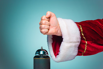 Image showing Hand of Santa Claus pressing on the bell
