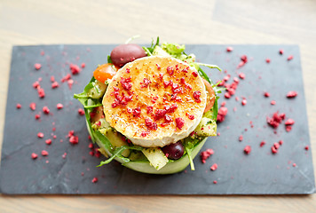 Image showing goat cheese salad with vegetables at restaurant