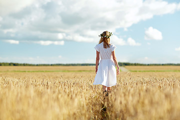 Image showing happy young woman in flower wreath on cereal field