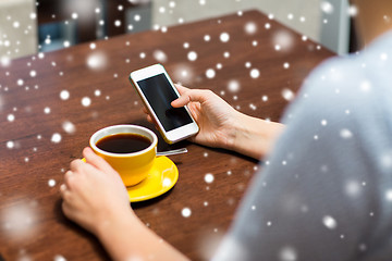 Image showing woman with smartphone drinking coffee at cafe