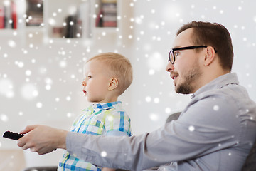 Image showing father and son with remote watching tv at home