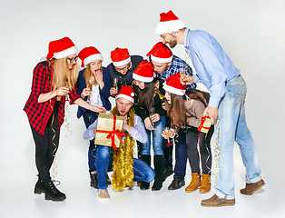 Image showing Many young women and men drinking at christmas party