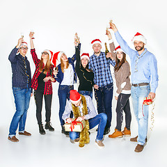 Image showing Many young women and men drinking at christmas party