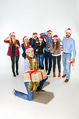 Image showing Many young women and men drinking at christmas party