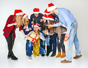 Image showing Many young women and men drinking at christmas party