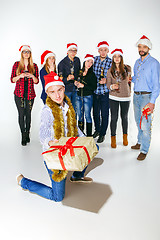 Image showing Many young women and men drinking at christmas party