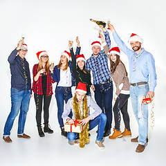 Image showing Many young women and men drinking at christmas party