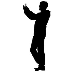 Image showing Silhouettes man taking selfie with smartphone on white background.