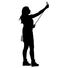 Image showing Silhouettes woman taking selfie with smartphone on white background.