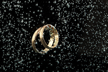 Image showing Golden Rings In The Water