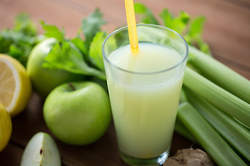 Image showing close up of glass with green juice and vegetables