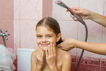 Image showing Seven-year girl bathe in a bath under the shower