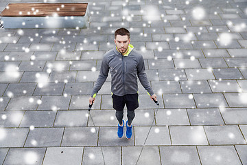 Image showing man exercising with jump-rope outdoors