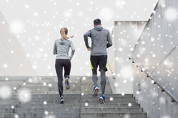 Image showing couple of sportsmen running upstairs outdoors