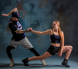 Image showing The two young girl and boy dancing hip hop in the studio