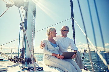 Image showing senior couple with tablet pc on sail boat or yacht