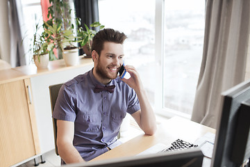 Image showing happy creative male worker calling on smarphone