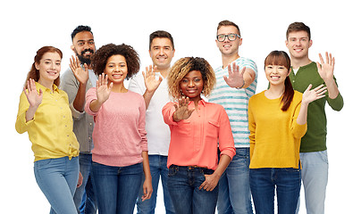 Image showing international group of happy people waving hand