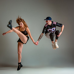 Image showing The two young girl and boy dancing hip hop in the studio