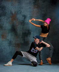 Image showing The two young girl and boy dancing hip hop in the studio