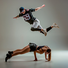 Image showing The two young girl and boy dancing hip hop in the studio