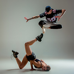 Image showing The two young girl and boy dancing hip hop in the studio