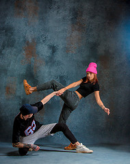 Image showing The two young girl and boy dancing hip hop in the studio