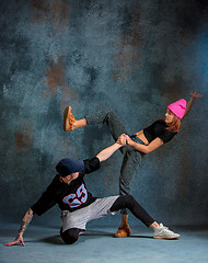 Image showing The two young girl and boy dancing hip hop in the studio