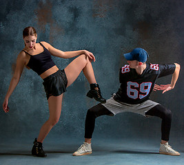 Image showing The two young girl and boy dancing hip hop in the studio