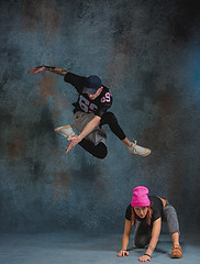 Image showing The two young girl and boy dancing hip hop in the studio