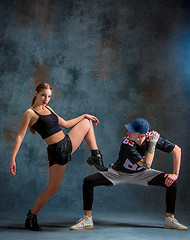 Image showing The two young girl and boy dancing hip hop in the studio