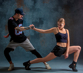 Image showing The two young girl and boy dancing hip hop in the studio