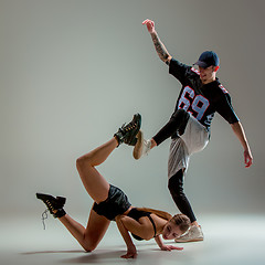 Image showing The two young girl and boy dancing hip hop in the studio