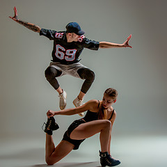 Image showing The two young girl and boy dancing hip hop in the studio