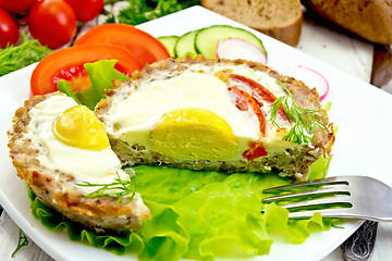 Image showing Tartlet meat with egg cut and vegetables on light board