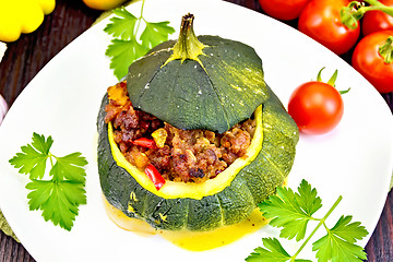 Image showing Squash green stuffed with meat on dark board