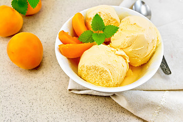 Image showing Ice cream apricot in white bowl on napkin