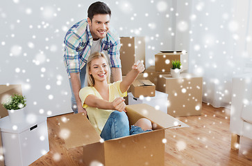 Image showing happy couple having fun with boxes at new home