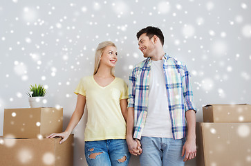 Image showing smiling couple with big boxes moving to new home