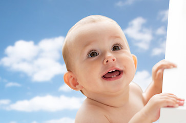 Image showing happy little baby boy or girl looking up