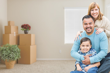 Image showing Mixed Race Family with Son in Room with Packed Moving Boxes