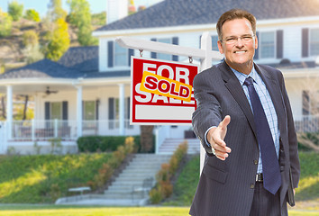 Image showing Male Agent Reaching for Hand Shake in Front of House and Sold Re