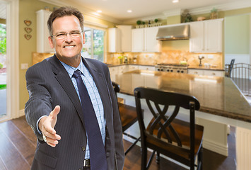 Image showing Male Agent Reaching for Hand Shake in New Kitchen