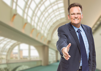 Image showing Businessman Reaching for Hand Shake Inside Corporate Building